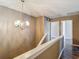 Upstairs hallway featuring updated floors and chandelier fixture at 1211 W Horatio St # A, Tampa, FL 33606