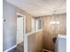 A bright hallway illuminated by a chandelier shows multiple entryways and stair access at 1211 W Horatio St # A, Tampa, FL 33606