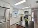 Bright kitchen features white cabinets, stainless steel appliances, and wood-look flooring at 1211 W Horatio St # A, Tampa, FL 33606