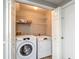 Convenient laundry room featuring a washer and dryer with overhead shelving at 1211 W Horatio St # A, Tampa, FL 33606