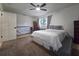 Spacious bedroom featuring large windows, carpet flooring, and a ceiling fan at 12701 N 57Th St, Tampa, FL 33617