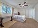Inviting bedroom with a ceiling fan, and a large window for natural light at 12701 N 57Th St, Tampa, FL 33617