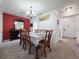 Traditional dining room with a red accent wall, carpet, and a classic chandelier at 12701 N 57Th St, Tampa, FL 33617