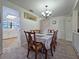 Bright dining area featuring carpet and easy access to the kitchen and staircase at 12701 N 57Th St, Tampa, FL 33617