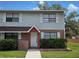Charming two-story home with vinyl siding, brick accents, white door and white-trimmed windows at 12701 N 57Th St, Tampa, FL 33617