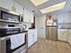 Well-equipped kitchen with stainless steel appliances, white cabinets, and ample counter space at 12701 N 57Th St, Tampa, FL 33617