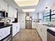 Bright kitchen with white cabinetry, stainless steel appliances, and plenty of countertop space at 12701 N 57Th St, Tampa, FL 33617