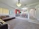 Cozy living area flows into dining space, featuring carpet floors and plenty of natural light at 12701 N 57Th St, Tampa, FL 33617