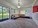 Bright living room featuring plush carpet, a large sectional couch, and sliding glass doors to the patio at 12701 N 57Th St, Tampa, FL 33617