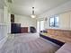 Spacious living room with carpet floors, an overhead light fixture, and plenty of natural light at 12701 N 57Th St, Tampa, FL 33617