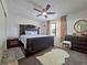 Comfortable main bedroom featuring a ceiling fan, stylish decor and a plush rug at 12701 N 57Th St, Tampa, FL 33617