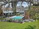 Community pool surrounded by lush greenery and lounging area at 12701 N 57Th St, Tampa, FL 33617