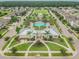 Aerial view of the community park featuring a pool, playground, and beautifully landscaped common areas for recreation at 13118 Rain Lily Dr, Riverview, FL 33579