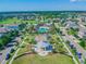 An aerial view of a well-maintained community featuring a playground, pool, sidewalks, landscaping, and residential homes at 13118 Rain Lily Dr, Riverview, FL 33579