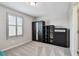 Cozy bedroom with neutral carpet, a large window, and modern dark furniture at 13118 Rain Lily Dr, Riverview, FL 33579