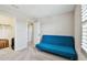 Bedroom with neutral carpet, a futon, and two entryways to other rooms at 13118 Rain Lily Dr, Riverview, FL 33579