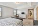 Bright bedroom featuring wood-look floors, shuttered windows, and a walk-in closet at 13118 Rain Lily Dr, Riverview, FL 33579