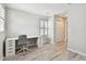 Bedroom featuring stylish wood flooring, a large window, and a desk with drawers at 13118 Rain Lily Dr, Riverview, FL 33579