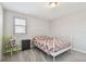 Cozy bedroom with neutral carpet, a white bed frame, and a window with plantation shutters at 13118 Rain Lily Dr, Riverview, FL 33579