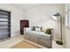 Neutral bedroom with a cozy daybed, area rug, modern lamp, and built-in shelves at 13118 Rain Lily Dr, Riverview, FL 33579