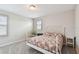 Bright bedroom with neutral carpet, a white bed frame, and a window with plantation shutters at 13118 Rain Lily Dr, Riverview, FL 33579