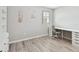 Bright bedroom featuring stylish wood flooring, a large window, and a desk with drawers at 13118 Rain Lily Dr, Riverview, FL 33579