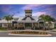 Exterior view of neighborhood clubhouse featuring manicured landscaping, sidewalks and ample parking at 13118 Rain Lily Dr, Riverview, FL 33579