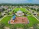 Aerial view of community park featuring a playground and landscaped common areas for residents to enjoy at 13118 Rain Lily Dr, Riverview, FL 33579