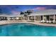 Luxurious community pool area with ample seating and stylish architecture creating an inviting atmosphere at 13118 Rain Lily Dr, Riverview, FL 33579