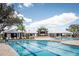 Resort-style community pool with sun loungers and a modern clubhouse, perfect for relaxation and socializing at 13118 Rain Lily Dr, Riverview, FL 33579