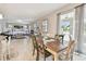 Dining area with table, view of the living room, and backyard through sliding glass doors with sheer curtains at 13118 Rain Lily Dr, Riverview, FL 33579