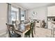 Bright dining area with tile floors, modern furnishings, backyard view, and direct access to the kitchen at 13118 Rain Lily Dr, Riverview, FL 33579