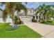 Inviting two-story home boasting tropical landscaping, mature palms, and a well-kept lawn at 13118 Rain Lily Dr, Riverview, FL 33579