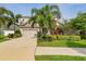 Charming two-story home featuring a well-manicured lawn, lush landscaping, and a two-car garage at 13118 Rain Lily Dr, Riverview, FL 33579