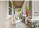 Relaxing front porch with white rocking chairs and views of the colorful landscaping at 13118 Rain Lily Dr, Riverview, FL 33579