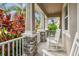 Inviting covered front porch with white rocking chairs and classic stone columns at 13118 Rain Lily Dr, Riverview, FL 33579