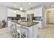 Modern kitchen with white cabinets, granite countertops, and stainless steel appliances at 13118 Rain Lily Dr, Riverview, FL 33579