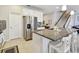 Stylish kitchen with a granite island, stainless steel fridge, and bar seating at 13118 Rain Lily Dr, Riverview, FL 33579