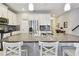 Kitchen island with granite countertops, stainless steel appliances, white cabinets, and bar stool seating at 13118 Rain Lily Dr, Riverview, FL 33579