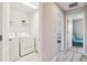 Laundry room featuring washer, dryer, wire shelving, and wood-look flooring at 13118 Rain Lily Dr, Riverview, FL 33579