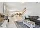 Open-concept living area featuring white tile flooring and seamlessly connected kitchen and dining spaces at 13118 Rain Lily Dr, Riverview, FL 33579