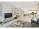 Inviting living room area showcasing seamless flow into kitchen and dining spaces, plus stylish window shutters at 13118 Rain Lily Dr, Riverview, FL 33579