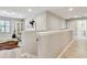Upstairs loft area with modern decor, stylish flooring, and access to the laundry room at 13118 Rain Lily Dr, Riverview, FL 33579