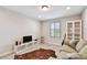 Relaxing loft featuring stylish flooring, a comfortable couch, and an accent rug at 13118 Rain Lily Dr, Riverview, FL 33579