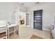 Bright office featuring French doors, a bookcase, tile flooring and a white desk at 13118 Rain Lily Dr, Riverview, FL 33579