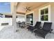 Inviting covered patio featuring lounge chairs and an outdoor dining area, perfect for entertaining or relaxing at 13118 Rain Lily Dr, Riverview, FL 33579