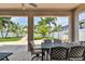 Covered patio with a view of the backyard that includes an outdoor dining area with comfortable seating at 13118 Rain Lily Dr, Riverview, FL 33579