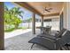 Covered patio featuring lounge chairs, an outdoor dining area, ceiling fan, and view of the backyard at 13118 Rain Lily Dr, Riverview, FL 33579