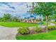 Neighborhood playground featuring slides, benches, shade trees, and manicured landscaping in a well-maintained community at 13118 Rain Lily Dr, Riverview, FL 33579