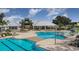 Community pool area featuring pools, lounge chairs, umbrellas, and a covered pavilion at 13118 Rain Lily Dr, Riverview, FL 33579